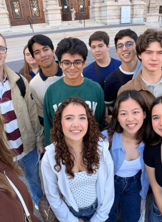 Members of our school group smile for a close-up selfie outside the museum entrance.