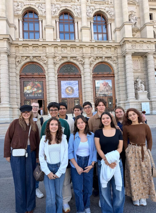 Our Schloss Krumbach International School students explore a museum gallery surrounded by Egyptian coffins and painted walls.