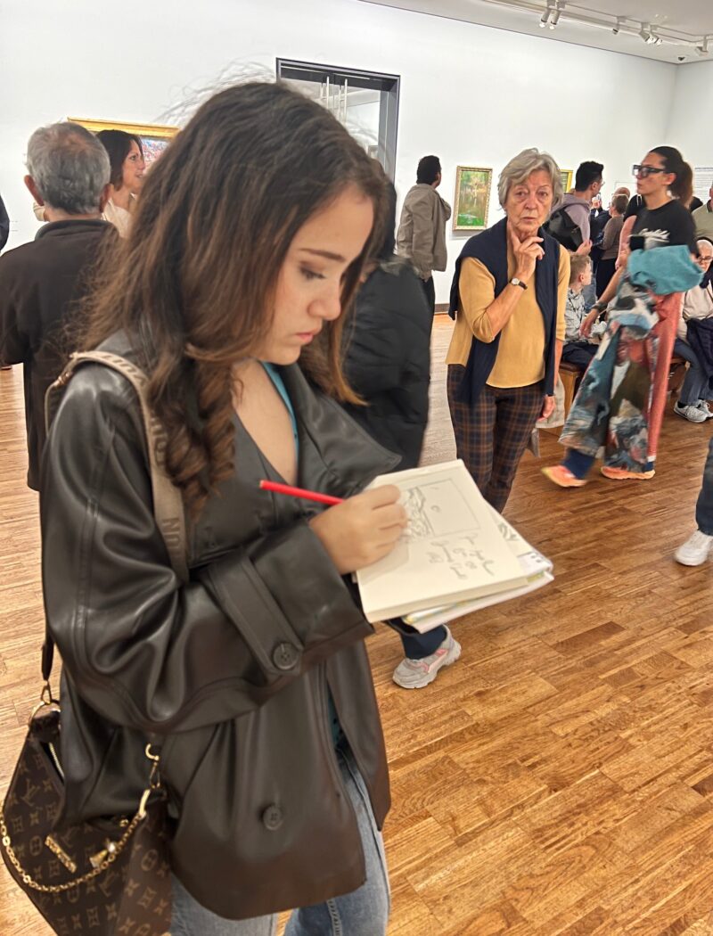 Schloss Krumbach International School IB Visual Arts student making sketches and notes during an educational visit to the Albertina.