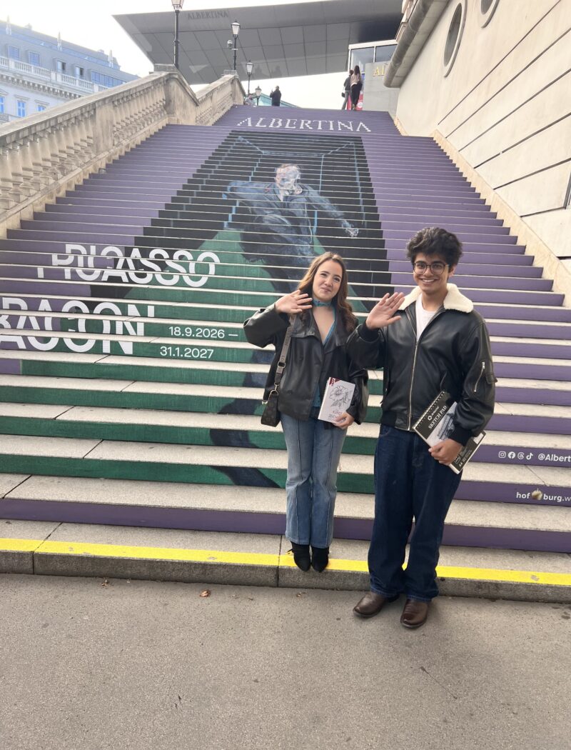 Schloss Krumbach IB Visual Arts students standing beside the Monet to Chagall exhibition poster at the Albertina Museum.