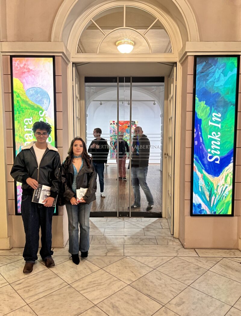 Two Schloss Krumbach International School students standing at the entrance to an exhibition gallery at the Albertina Museum in Vienna.