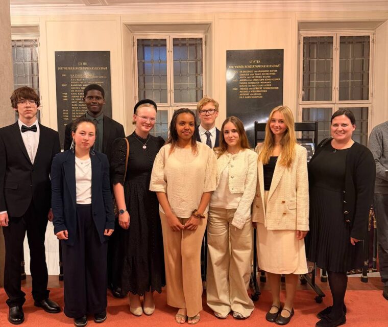 Group of Schloss Krumbach International School students and accompanying adult posing together during their visit to the Wiener Konzerthaus.