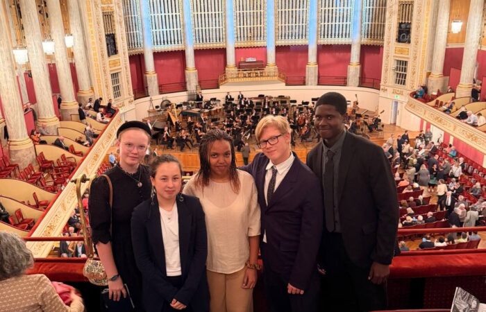 Five Schloss Krumbach International School students posing on the balcony overlooking the orchestra at the Wiener Konzerthaus.