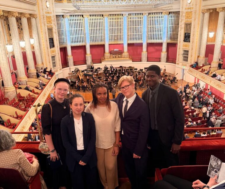 Five Schloss Krumbach International School students posing on the balcony overlooking the orchestra at the Wiener Konzerthaus.
