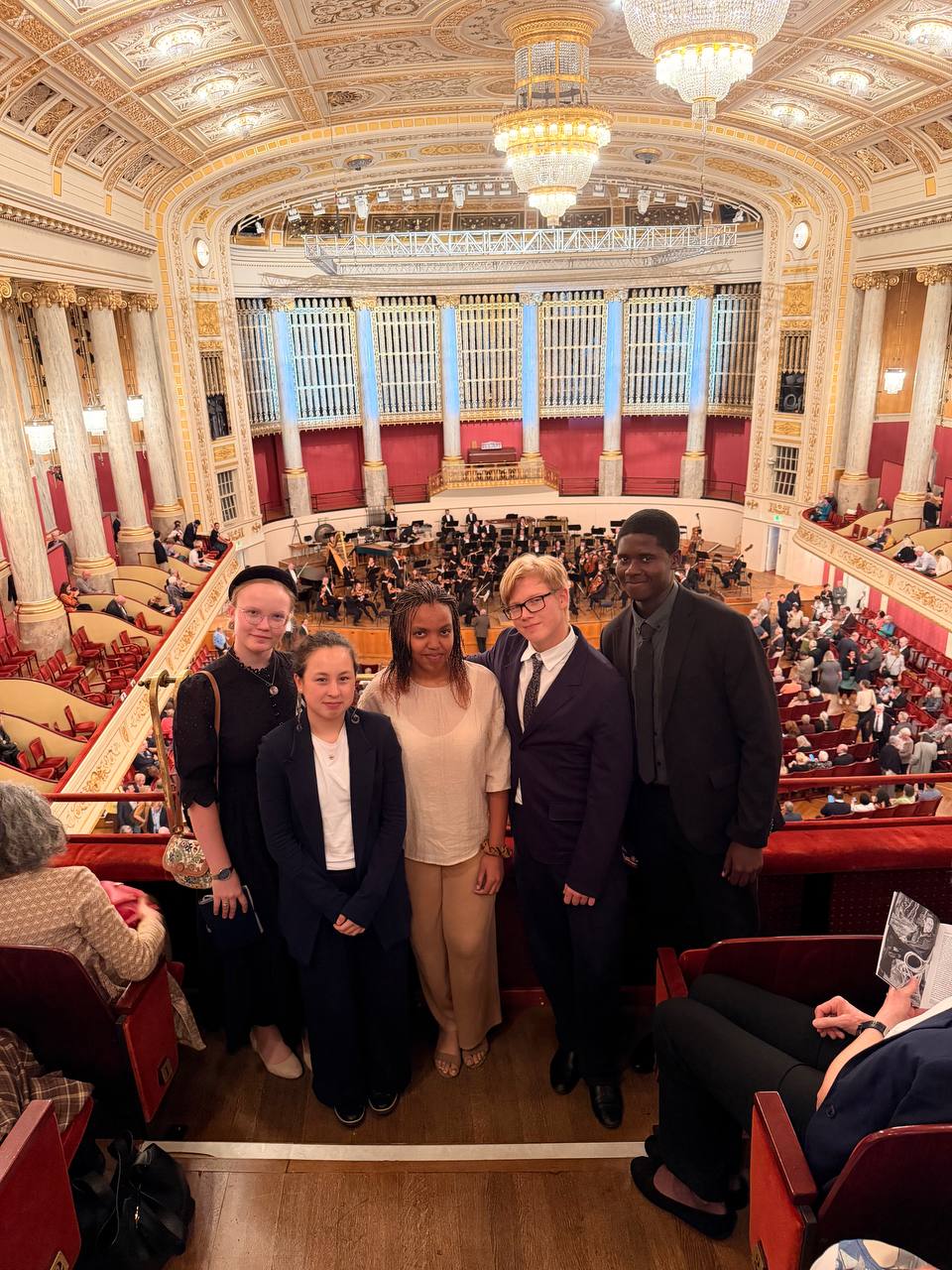 Five Schloss Krumbach International School students posing on the balcony overlooking the orchestra at the Wiener Konzerthaus.