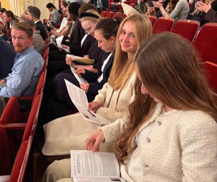 Schloss Krumbach International School students reading concert programmes while seated in the Wiener Konzerthaus auditorium.